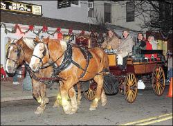 JERRY WOLKOWITZ Rusty and Winston lead a holiday carriage ride from Railroad Avenue in Jamesburg. On board, Kevin McMinn holds the reins while Roger Dreyling (front right) narrates the tour.