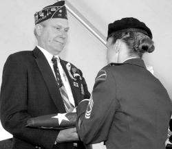 FARRAH MAFFAI Milltown Joyce Kilmer American Legion Post 25 Commander Bob Richards is presented with a flag at a ceremony Friday in which the U.S. Postal Service unveiled its new Purple Heart stamp.