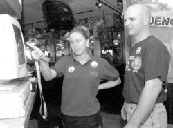 VERONICA YANKOWSKI Applebee&rsquo;s employee Jarra Flanagan shows Milltown Police Officer Dan Cononie how to use the computer during Thursday&rsquo;s &ldquo;Tip a Cop&rdquo; event to benefit the Special Olympics.