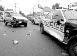 STEVEN M. BARON South River Patrolman Kevin Nielsen suffered injuries after a Honda (l) collided with the officer&rsquo;s patrol vehicle at Main Street and Old Bridge Turnpike around 8:30 a.m. last Thursday.