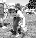 Jessica Dias, 9, (top) ducks through a hoop while scrambling to complete the obstacle course during Fun Day at South River Elementary School Friday.