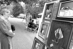 PHOTOS BY CHRIS KELLY Jane Butieb (top) of Perth Amboy looks over artwork by Joseph Parascand at the arts and crafts show Sunday  sponsored by the South River Cultural Arts and Heritage Commission at the South River Public Library.