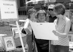 VERONICA YANKOWSKI Edith Weinstein (r) looks over the work of smiling artist Margo Hirsh of East Brunswick during the township&rsquo;s Visual Arts Celebration 2003, held Saturday at the East Brunswick municipal complex.