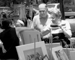 VERONICA YANKOWSKI A couple of art admirers check out one of the displays during Saturday&rsquo;s Visual Arts Celebration 2003, which featured more than 100 artists whose displays surrounded the pond at the East Brunswick municipal complex.