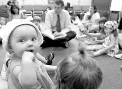 JEFF GRANIT Ten-month-old Elizabeth Sullivan sits in during Congressman Rush Holt&rsquo;s visit to the summer reading program at the library.