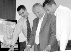 At left, Sam (l-r), Omar and Wasseem Boraie look over one of their redevelopment plans alongside their design of a New Brunswick office building.