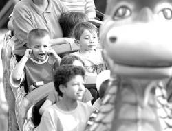 VERONICA YANKOWSKI Richard Edwards Jr., 5, (above) of Jamesburg holds his ears while he enjoys a ride down the roller coaster at the Monmouth County Fair in Freehold Township last Thursday.