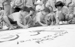 Above, children sign a banner  pledging they will not abuse drugs or alcohol.