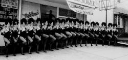 A Rockettes influence is seen in the kick line in front of the Milltown studio. 