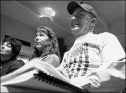 Kevin Coyle, (r) a fifth-grade teacher at Ocean Avenue Elementary School, Middletown, and Pat Dolan, a teacher at Middletown High School North, listen to Gov. McGreevey speak during the Teacher Town Meeting Jan. 29.