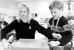 From right, Petra Leonard and son Justin, 6, of Tinton Falls, prepare boxes to send school supplies and children&rsquo;s books to Hurricane Katrina-displaced children in Mobile, Ala., during Mahala F. Atchison School&rsquo;s Operation: Helping Hands on Dec. 9; Sabrina Lamana, 7, Tinton Falls, starts a pile of markers to be sent; while Maggie Gaal (l) and Ashleigh Watrous pile notebooks to be added to the 50 boxes of supplies to be sent.  
