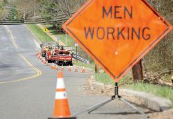  Members of the Marlboro Department of Public Works make repairs to Robertsville Road on April 22. Local towns emphasize different uses of tax money, including enhanced road programs and senior-service spending, to fit the needs of the individual communities. 
