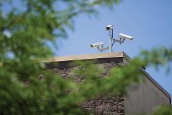  The widespread use of surveillance cameras, such as these atop a local retail building, have sparked discussions at the local and state levels about citizens&rsquo; right to privacy. 