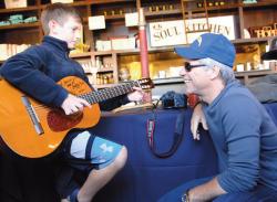  Jon Bon Jovi, right, listens to Jason Recht of HoHoKus play the guitar during the second annual JBJ Soul Kitchen Chili Cookoff on Oct. 10. 