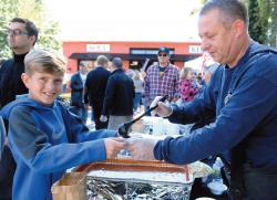  Ben Fleming of Illinois, left, gets some chili from Lance Habeny of the Atlantic Highlands Fire Department during the second annual JBJ Soul Kitchen Chili Cookoff on Oct. 10. The event featured entries by local police, fire and emergency responders as a way to thank them for their efforts.  PHOTOS BY FRANK GALIPO 