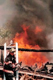 Flames leap out of the Cabin restaurant in Howell as firefighters battle a blaze on Saturday. 