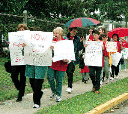 KATHY BARATTA Their sentiments clear on the signs they carry,          with slogans such as &ldquo;Now do we look happy?,&rdquo; Manalapan-Englishtown Regional School District teachers and librarians rally for their cause. 