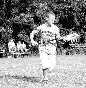 MARIE ORTIZ Bill Menzel, 12, of Freehold, takes off with his lacrosse stick during a clinic held at Liberty Oak Park in Freehold Township on Sunday. 