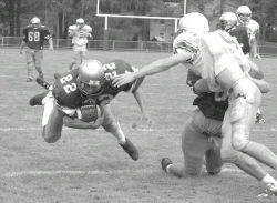 JERRY WOLKOWITZ Freehold&rsquo;s Keith Reed lunges for extra yardage during a scrimmage against Monsignor Donovan on Friday. 