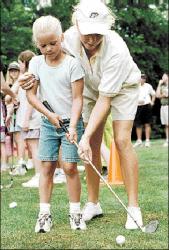 FARRAH MAFFAI Professional golfer Stacy Orschell shows Freehold&rsquo;s Kelli Schaefer, 6, how to approach the ball during a clinic at Knob Hill, Manalapan, July 11. Golf pros were at Knob Hill to compete in the Futures Classic. For more, see sports.