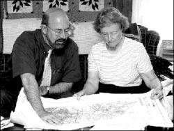 JERRY WOLKOWITZ  Planning consultant John Madden and Helen H. Heinrich, a research associate with the New Jersey Farm Bureau, review a zoning map of Manalapan during a meeting with members of Farmers Against Rezoning in Manalapan.