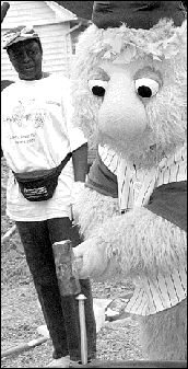 Buster, the mascot of the Lakewood BlueClaws baseball team, offers his support and mascot muscle to the community effort that saw a playground constructed.