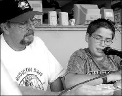 FARRAH MAFFAI Shawn Reu, 12, of Oakhurst, announces the Lakewood BlueClaws starting lineup on Aug. 15 with a little help from Captain Jack. Shawn was one of the winners in a contest sponsored by Greater Media Newspapers.