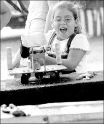 SARAH McCOLGAN  Elissa Stagliano, 6, of Colts Neck tries her luck at one of the games at the Colts Neck Fair, which made its annual stop in town Aug. 16-19.