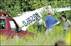 JERRY WOLKOWITZ On Monday, investigators examine the scene of a plane crash in Marlboro that claimed the lives of two men. See story, page 7.