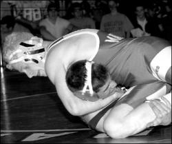 JERRY WOLKOWITZ  Manalapan&rsquo;s Dan Hilt works on pinning Howell&rsquo;s Jay Ucci during the 112-pound final at the District 21 championship at Manalapan High School on Saturday. Hilt won the match with a fall at 3:22.
