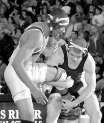 PHOTOS BY CHRIS KELLY  staff Above, Freehold Township&rsquo;s Pete Reilly tries to score a single-leg takedown during his quarterfinal win over Lakewood&rsquo;s Henry Martin on Friday. At left, Marlboro&rsquo;s Nick Parisi controls Jackson&rsquo;s Alex Ginsberg during their 160-pound bout.