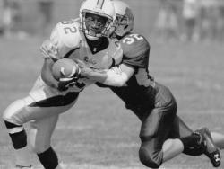 Howell running back Mike Hering (left) tries to break free from the grips of Colts Neck linebacker Ryan Moore (right) during the first quarter of his team's 28-26 victory. 