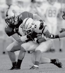 Colts Neck's Kevin Callelo (l) wraps up a Toms River South runner as Richie Foligno gets in on the tackle during Thursday's game. 