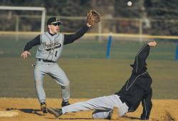 ERIC SUCAR staff Freehold High School's Mike Hembling waits for a throw as a base runner from Lawrence High School slides into second base during a preseason scrimmage in Freehold Borough on March 20. The spring sports season for area high school teams will begin on April 2. 