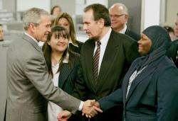 POOL PHOTO BY THOMAS P. COSTELLO/ASBURY PARK PRESS President George W. Bush shakes hands with Penny Meredith, a community education coordinator with Brand New Day, Elizabeth, as homeowners Theresa Torres, (l) of Kansas City, Kan., and Danny Cerchiaro, of Woodbridge, look on during the president's March 28 visit to Novadebt, a nonprofit financial-management/social-services agency and a member of the Hope Now alliance with offices in Freehold Township. For more on the president's visit, see page 3. 