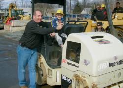 Michael Boliver took his turn riding a 2-ton roller with the help of Anthony Eosso, when the members of Cub Scout Pack 188 of Morganville visited the facilities of Eosso Brothers Paving, Hazlet. 