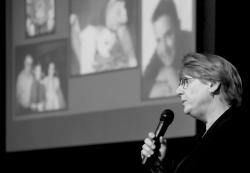 MATT DENTON Linda Surks speaks to the audience about losing her son to prescription drugs as pictures of him are projected in the background. 