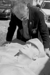Joseph Occhipinti examines damage done to part of a 9/11 monument. 