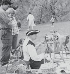 A representative of the Monmouth County Historical Association conducts a demonstration during Wool Days at the Holmes-Hendrickson House in Holmdel. The demonstration depicted is the "From Fiber to Fabric" traveling trunk program presented by the historical association to schools and community groups. 