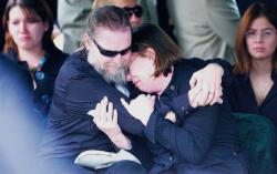 Mark and Jean Dammann (above) mourn the death of their son, U.S. Army Cpl. Brian M. Connelly, during services for the fallen soldier on March 7 at Forest Green Park Cemetery in Marlboro. Connelly's widow, Kara Connelly, holds an American flag and is comforted by a fellow mourner during the service. 