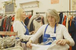 CLARE MARIE CELANO Sylvia Johnson (front), the volunteer manager of the St. Peter's Church Thrift Shop, Freehold Borough, and volunteer Elaine Zarr place clothes on the racks at the store. Johnson said that during the current economic times, more people are coming into the store to shop. 