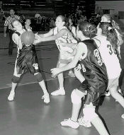 JEFF HUNTLEY Fifth- and sixth-grade girls from Old Bridge and Colts Neck scramble for the ball during a game at Old Bridge High School for the Old Bridge girls travel basketball league on Friday. 
