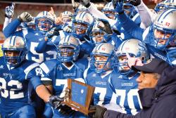 Sayreville War Memorial High School players celebrate with their NJSIAA Central Jersey Group IV sectional championship trophy after defeating Brick Memorial at the Rutgers University football stadium Dec. 4. The Bombers won 14-0. For more, see Sports. LAUREN CASSELBERRY 