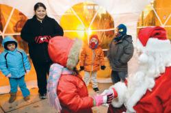 Children wait their turn to meet Santa Claus during South Amboy&rsquo;s annual Holiday Tree Lighting and Fire Truck Parade. The event was held at Transit Plaza on Dec. 14. More photos at gmnews.com. ERIC SUCAR staff 